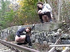 Two amateur brunette chicks wanna pee right on the train line